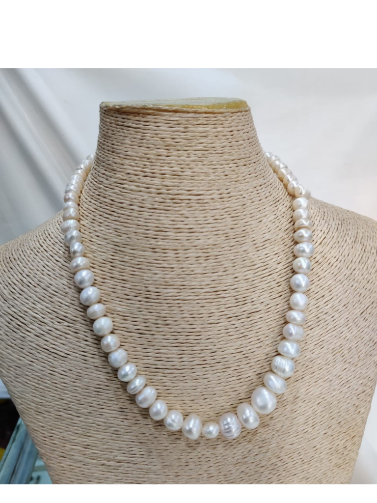 Freshwater Pearl Necklace displayed on a woven mannequin bust, featuring a single strand of luminous white pearls in varying sizesâhandcrafted and elegant.