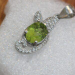 Handcrafted Peridot Pendant symbolizing emotional grounding and panic relief through ethical Afghan design