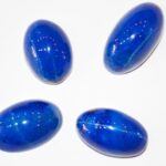 Raw lapis lazuli stone with deep blue hues and golden pyrite flecks, symbolizing truth and emotional healing.